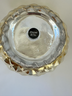 Close-up of wear and metallic-finish loss on the underside of Hazel & Co gold pineapple container.

