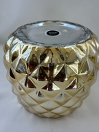 Close-up of wear and metallic-finish loss on the underside of Hazel & Co gold pineapple container.
