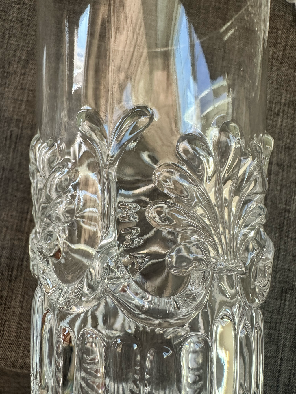 Close up of glass with mark MMA identifying them as reproductions from history. 