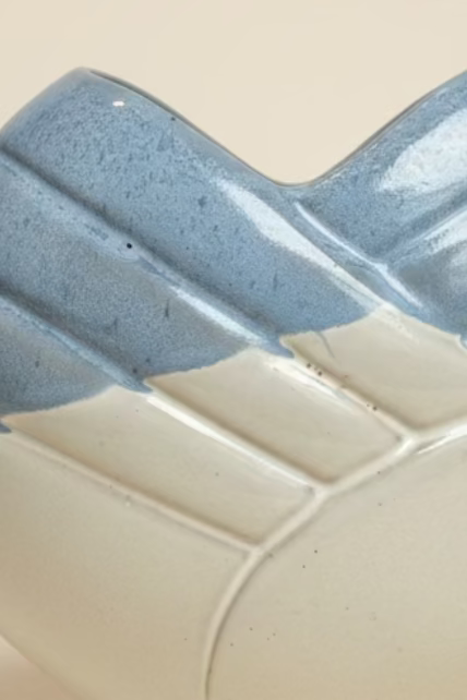 image showing tiny divot and 3 pock marks in ceramic finish. 