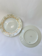 One Haviland Chambord plate shown face up beside another plate turned over to display the backstamp.

