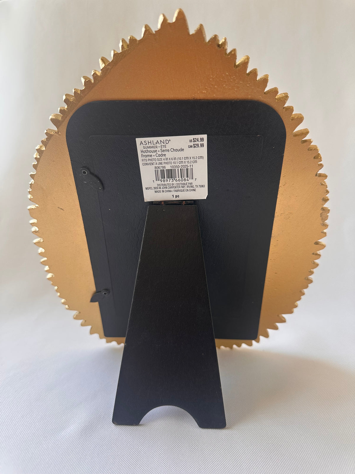 Back view of a Koolanoy round picture frame with a gold metallic inner border and a black outer frame, displayed on a black stand against a white background.