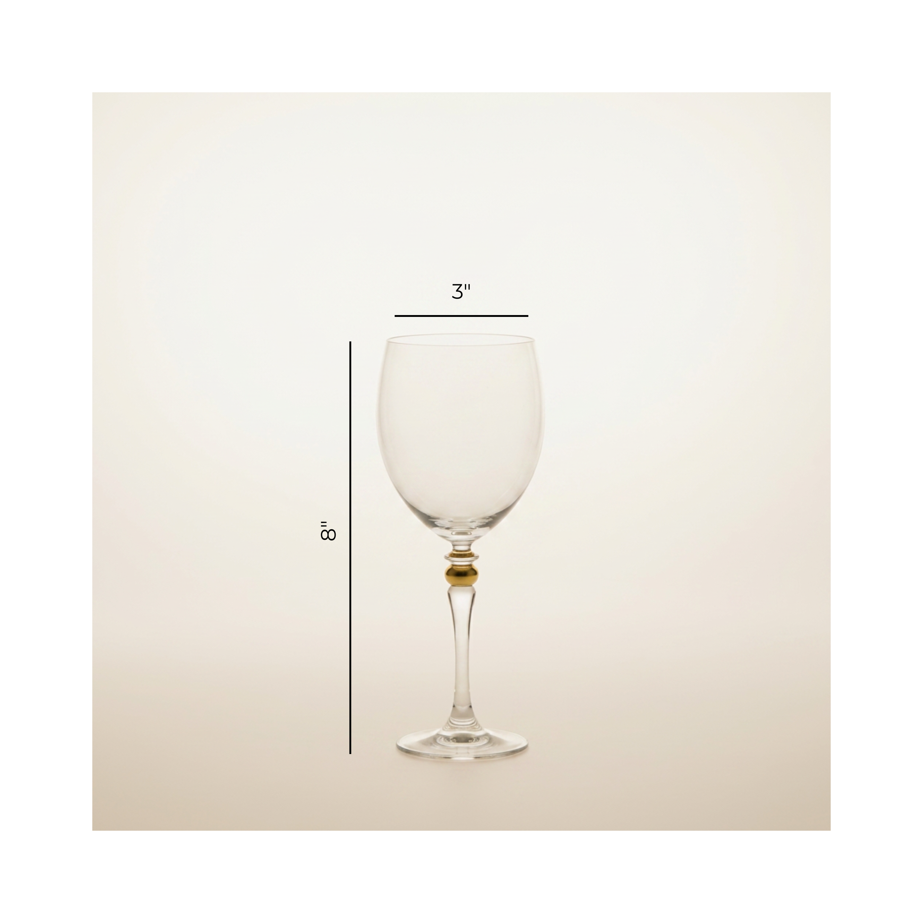 A clear wine glass with a small gold accent at the base of the stem, shown on a light beige background with dimension lines indicating 3 inches wide at the bowl and 8 inches tall.