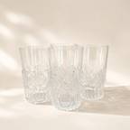 Set of four clear MMA-marked tumblers with raised fan and scroll decoration around the lower glass.
