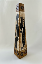 Three-quarter view of 13-inch ceramic vase with black raised motifs and earthy painted accents.