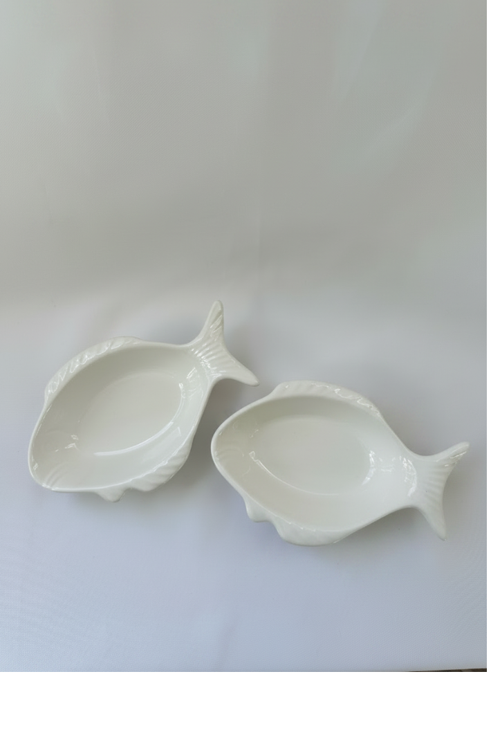 Set of two matching glossy white ceramic fish-shaped bowls with raised molded fish details.