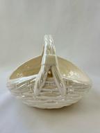 Side view of white ceramic basket bowl.
